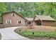 Charming home with wood siding, a curved driveway, and lush green landscaping provides great curb appeal at 402 Summit Ridge Ter, Lawrenceville, GA 30046