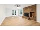 Bright living room featuring a brick fireplace and access to the outdoor patio at 402 Summit Ridge Ter, Lawrenceville, GA 30046