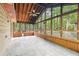 Enclosed patio with tile flooring, ceiling fan, and wooded views at 402 Summit Ridge Ter, Lawrenceville, GA 30046