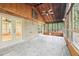 Enclosed patio with tile flooring, ceiling fan, and views of a wooded backyard at 402 Summit Ridge Ter, Lawrenceville, GA 30046