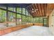 Enclosed patio with tile flooring, ceiling fan, and wooded views at 402 Summit Ridge Ter, Lawrenceville, GA 30046