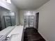 Bathroom showcasing a large vanity with double sinks and a glass enclosed walk-in shower at 7797 Sudbury Cir, Covington, GA 30014