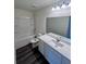 Bathroom with a large vanity, mirror, and shower and bath combo with tile surround at 7797 Sudbury Cir, Covington, GA 30014