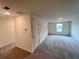 Spacious bedroom features neutral carpet, paint, and window letting in natural light at 7797 Sudbury Cir, Covington, GA 30014