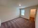 Bedroom with carpet, window, and a walk-in closet with shelving for storage at 7797 Sudbury Cir, Covington, GA 30014