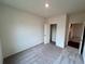 Cozy bedroom with neutral carpet, a closet, fresh paint, and ample natural light at 7797 Sudbury Cir, Covington, GA 30014