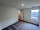 Bedroom includes neutral carpet, paint, window and closet space at 7797 Sudbury Cir, Covington, GA 30014