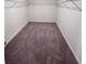 Spacious walk-in closet with carpeted flooring and ample wire shelving for storage at 7797 Sudbury Cir, Covington, GA 30014