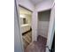 Hallway featuring entrance to the bathroom and walk-in closet with wire shelving at 7797 Sudbury Cir, Covington, GA 30014