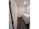 Functional laundry room with washer, dryer, and wood-look floors at 7797 Sudbury Cir, Covington, GA 30014