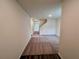 Spacious living room with neutral carpet and fresh paint, leading to the staircase at 7797 Sudbury Cir, Covington, GA 30014