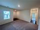 Inviting living room featuring neutral carpet, fresh paint, and ample natural light at 7797 Sudbury Cir, Covington, GA 30014