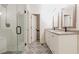 Modern bathroom with a glass-enclosed shower, double sink vanity, and decorative floor tiles at 3412 Collier Nw Dr, Atlanta, GA 30331