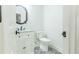 Stylish powder room with black and white patterned floor tiles, vanity, and a sleek mirror at 3412 Collier Nw Dr, Atlanta, GA 30331