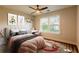Bright bedroom with decoratively painted walls, a ceiling fan, two windows, and neutral furnishings at 3412 Collier Nw Dr, Atlanta, GA 30331
