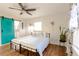 Bright bedroom with a unique sliding door, ceiling fan, and hardwood floors at 3412 Collier Nw Dr, Atlanta, GA 30331