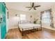 Comfortable bedroom with hardwood floors, a ceiling fan, and bright natural light at 3412 Collier Nw Dr, Atlanta, GA 30331