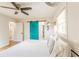 Bright bedroom with a unique sliding door, ceiling fan, and hardwood floors at 3412 Collier Nw Dr, Atlanta, GA 30331