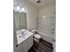 Bathroom with single sink vanity, a shower/tub combo, and modern fixtures at 7791 Sudbury Cir, Covington, GA 30014