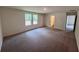 Spacious bedroom featuring two windows and neutral carpeting at 7791 Sudbury Cir, Covington, GA 30014