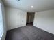 Cozy carpeted bedroom with a window and white door at 7791 Sudbury Cir, Covington, GA 30014
