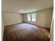 Bonus room featuring two windows and carpeted flooring at 7791 Sudbury Cir, Covington, GA 30014