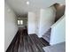View of the entryway featuring hardwood flooring, white walls, and a staircase at 7791 Sudbury Cir, Covington, GA 30014