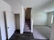 Entryway view with hardwood flooring, carpeted stairs, and a closet at 7791 Sudbury Cir, Covington, GA 30014