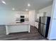 Kitchen features white cabinets, stainless steel appliances, and granite countertops at 7791 Sudbury Cir, Covington, GA 30014