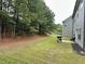 Spacious backyard featuring lush greenery, a patio area, and views of surrounding trees at 1452 Weatherbrook Cir, Lawrenceville, GA 30043