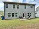 Large backyard with a grill, seating, manicured lawn, and modern gray siding at 1452 Weatherbrook Cir, Lawrenceville, GA 30043