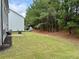 Expansive backyard with lush green grass, mature trees, and a patio area for outdoor entertaining at 1452 Weatherbrook Cir, Lawrenceville, GA 30043