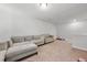 Spacious basement featuring a plush sofa, neutral carpet, and ample space for a home theater or playroom at 1452 Weatherbrook Cir, Lawrenceville, GA 30043