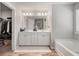Bright bathroom featuring a soaking tub, double vanity and neutral color palette at 1452 Weatherbrook Cir, Lawrenceville, GA 30043