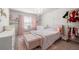 Cozy pink bedroom with a chandelier, large bed and shelving at 1452 Weatherbrook Cir, Lawrenceville, GA 30043