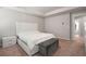 Inviting bedroom with a tray ceiling, upholstered bed and ottoman at 1452 Weatherbrook Cir, Lawrenceville, GA 30043