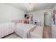 Bright bedroom with a crib, large bed and a chandelier at 1452 Weatherbrook Cir, Lawrenceville, GA 30043