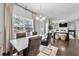 Stylish dining area with modern table, and a view of the living room, ideal for casual and formal dining at 1452 Weatherbrook Cir, Lawrenceville, GA 30043