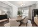 Elegant dining room with a large table, modern chandelier, and sophisticated decor for memorable gatherings at 1452 Weatherbrook Cir, Lawrenceville, GA 30043