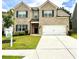 Charming two-story brick home with a well-manicured lawn and a two-car garage at 1452 Weatherbrook Cir, Lawrenceville, GA 30043