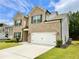 Beautiful two-story home featuring brick and siding, a manicured lawn, and an attached garage at 1452 Weatherbrook Cir, Lawrenceville, GA 30043
