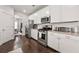 Contemporary kitchen with white cabinets, granite countertops, and stainless steel appliances, offering ample counter space at 1452 Weatherbrook Cir, Lawrenceville, GA 30043