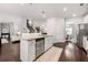 Gourmet kitchen featuring a central island with granite countertops, stainless appliances, and dark wood flooring at 1452 Weatherbrook Cir, Lawrenceville, GA 30043