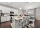 Open-concept kitchen showcases a granite island with seating, modern lighting, and sleek stainless steel appliances at 1452 Weatherbrook Cir, Lawrenceville, GA 30043