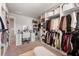 Large walk-in closet featuring custom shelving, racks and vanity area at 1452 Weatherbrook Cir, Lawrenceville, GA 30043