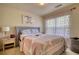 Bedroom featuring a queen-size bed, nightstand, and decorative lamp at 2160 Dillard Xing, Tucker, GA 30084