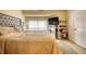 Bedroom with upholstered headboard, plush bedding, and a mirrored shelf for storage at 2160 Dillard Xing, Tucker, GA 30084