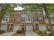 Attractive brick townhome featuring a one-car garage and well-manicured landscaping that enhances its curb appeal at 2160 Dillard Xing, Tucker, GA 30084