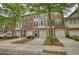 Attractive brick townhome featuring a one-car garage and well-manicured landscaping that enhances its curb appeal at 2160 Dillard Xing, Tucker, GA 30084