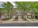 Attractive brick townhome featuring a one-car garage and well-manicured landscaping that enhances its curb appeal at 2160 Dillard Xing, Tucker, GA 30084